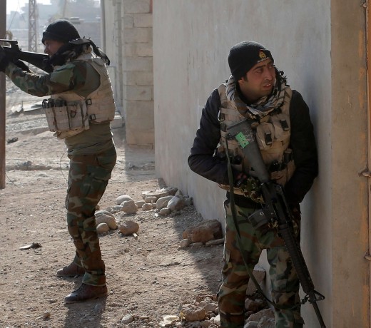 An Iraqi soldier fires during clashes with Islamic State fighters near Mosul. Photo: Reuters