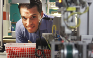 Clearly CEO Roy Hessel peers through an opening at his company's Vancouver manufacturing factility in the Broadway Tech Centre. Photo: Rob Kruyt