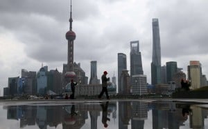 People walk on the bund in front of the financial district of Pudong in Shanghai. Demand for tax planning experts is rising in China. Photo: Reuters