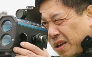 inspector Lam Yam-man tests a laser gun in 2008.
