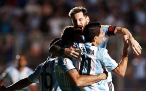 Argentina's Lucas Pratto (C) is embraced by teammates Lionel Messi and Angel Di Maria after he scored his team's second goal. REUTERS/Enrique Marcarian