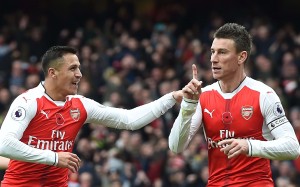 Arsenal's Laurent Koscielny (right) celebrates with Alexis Sanchez after Tottenham's Kevin Wimmer scored an own goal during their match on November 6. Photo: EPA