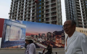 A billboard advertises a new housing complex under construction in Beijing. New home price growth in the city fell sharply, from 4.9 per cent in September to 0.6 per cent in October. Photo: AFP