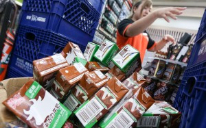 Staff at the 7-Eleven store at Ngau Tau Kok MTR station clear chocolate milk cartons from the shelves. Photo: Dickson Lee