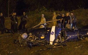 Police gather at a military helicopter which crashed in Rio de Janeiro. Photo: AP Police gather at a military helicopter which crashed in Rio de Janeiro. Photo: AP