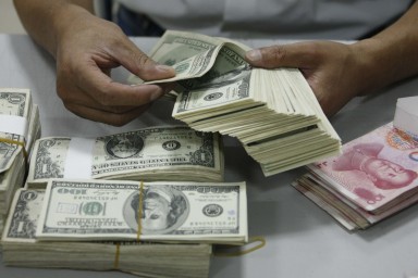 The exchange rate for yuan against the US dollar traded within China broke the key level of 6.8 last week. Photo: Reuters