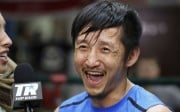 Zou Shiming smiles during a tv interview in June. (AP Photo/Mark Lennihan).