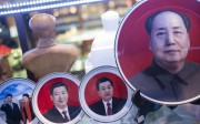 Portraits of Chinese leaders, including Xi Jinping, left, and Mao Zedong, right, on display in a shop in Tiananmen Square at the same time as the plenum. Photo: AFP