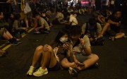 Protesters sit earlier this month on a main street which has been blocked off, amid demonstrations against Beijing’s decision to interpret the Basic Law provision on oath-taking. Photo: AFP Protesters sit earlier this month on a main street which has been blocked off, amid demonstrations against Beijing’s decision to interpret the Basic Law provision on oath-taking. Photo: AFP