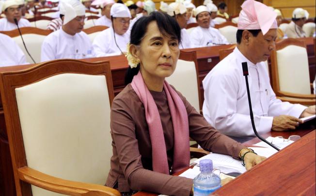 Myanmar's Opposition leader Aung San Suu Kyi, center, attends a regular session of the parliament at Myanmar Lower House on Tuesday, Aug. 14, 2012, in Naypyitaw, Myanmar.  AP Photo/Khin Maung Win