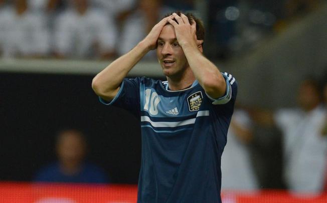 Argentina's Lionel Messi holds his head after having a penalty saved in Frankfurt. Photo: AFP