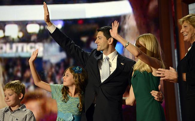 Republican vice presidential nominee Paul Ryan and his family wave at the end of Ryan's speech at the Tampa Bay Times Forum in Florida on Thursday. Photo: AFP 