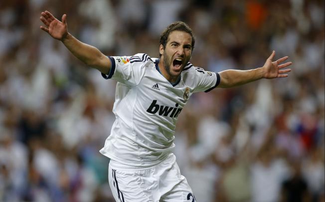 Real Madrid's Gonzalo Higuain celebrates after scoring a goal during the second leg of the Spanish Super Cup against FC Barcelona. Photo: AP