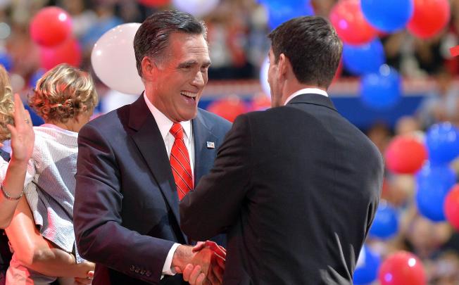 Republican presidential nominee Mitt Romney shakes the hand of his running mate, Paul Ryan, after speaking at the national convention in Florida. Photo: AFP