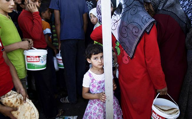 A Syrian girl at the Bab Al-Salameh border crossing where refugees wait in hope of entering one of the refugee camps in Turkey, near the Syrian town of Azaz. Photo: AP