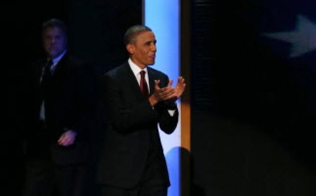US President Barack Obama walks on to the stage after Former US President Bill Clinton speaks during day two of the Democratic National Convention. Photo: AFP