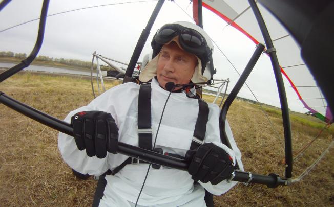 Russian President Vladimir Putin sits in a motorised hand glider at the Kushevat ornithological station near the city of Salekhard in Yamalo-Nenetsky region, Russia, as he takes part in a scientific project as part of the 'Flight of Hope' aiming to preserve Red Book crane species by showing the young birds their flying route. Photo: EPA
