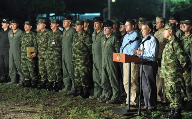 Colombian President Juan Manuel Santos, second right, speaking next to the Minister of Defence Juan Carlos Pinzon, third right, after a meeting with military high commanders on Thursday. Photo: EPA