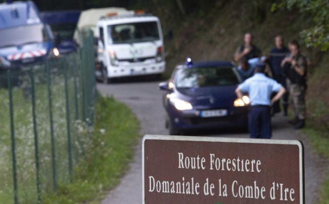 French police escort the car involved in the shooting of a British family on Wednesday in Dominiale de la Combe d'Ire near Chevaline. Photo: EPA
