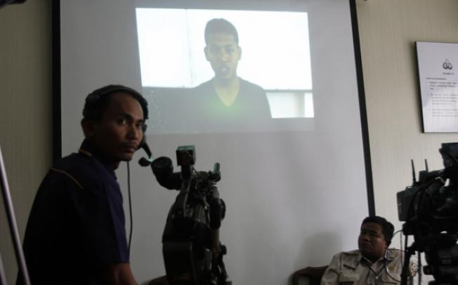 A TV cameraman films the interrogation video of terror suspect Bayu Setiono released by police on Thursday. Photo: AP