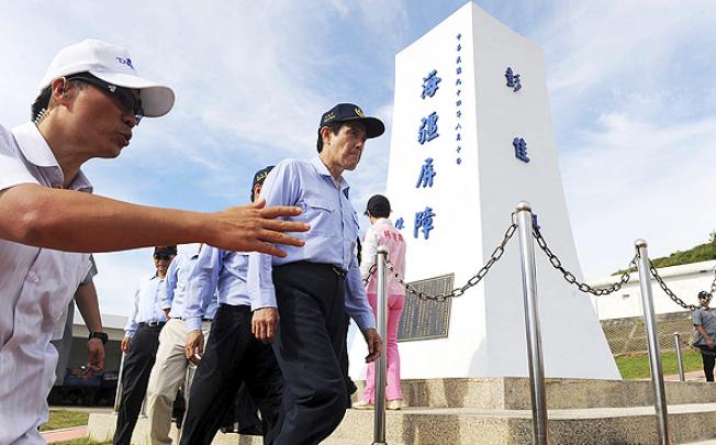 Taiwan President Ma Ying-jeou walks in front of a landmark on Pengjia Islet, 140km northeast of Taiwan in the East China Sea. Photo: Reuters