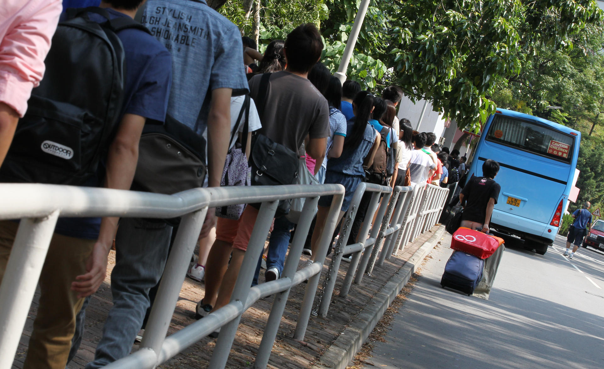 Students making their way to Chinese University queue for a shuttle bus near the University MTR station during a hectic first day of the academic year yesterday. Photo: Nora Tam