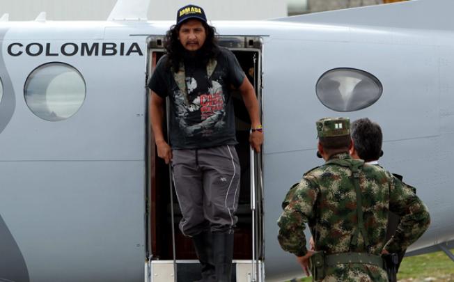 Ecuadorean citizen Orlando Sigifredo Ibarra Sarmiento exits a military airplane in Bogota on Monday. Photo: EPA