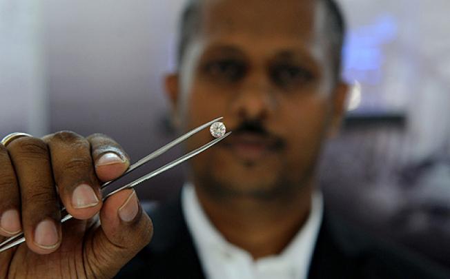 Suresh de Silva, director of the Belgrade International gem store, shows a 1.5-carat diamond similar to the one that was stolen. Photo: AFP