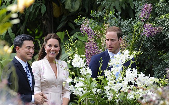 Prince William (right) and Catherine take a tour of Singapore’s Botanic Gardens with Poon Hong Yuen of the National Parks Board. An orchid will be named after the couple. Photo: EPA