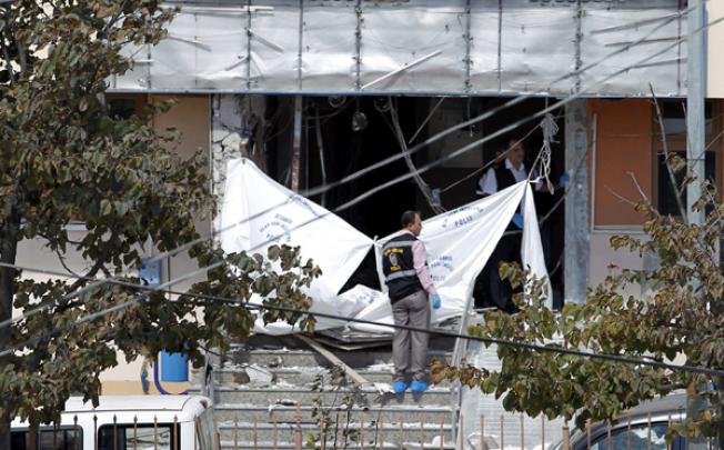 Turkish forensic officers search for evidence at the area after an explosion at Gazi Police station in Sultangazi district in Istanbul on Tuesday. Photo: EPA