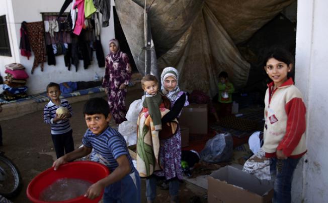 Syrian children, who fled their homes due to government shelling, take refuge with their families at Bab Al-Salameh crossing border, hoping to cross to one of the refugee camps in Turkey, near the Syrian town of Azaz. Photo: AP 
