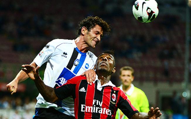 AC Milan's forward Kevin Constant (right) fights for the ball in a match against Atalanta on Saturday. Photo: AFP