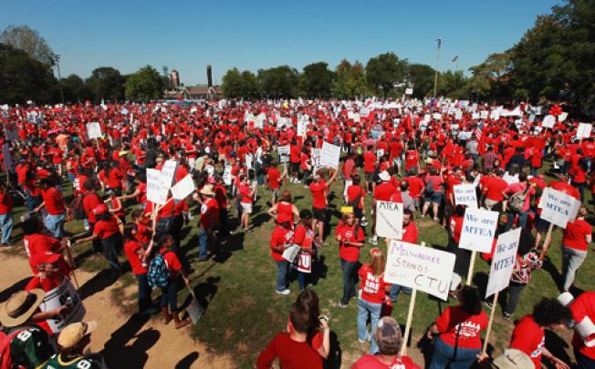 Teachers on strike in Chicago attend a rally at Union Park on Saturday. The strike extends to a sixth day on Monday. Photo: AFP