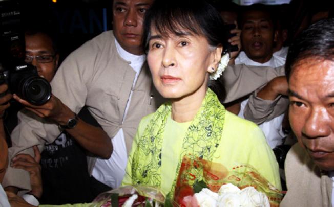 Myanmar opposition leader Aung San Suu Kyi arrives at Yangon airport to leave for the United States on Sunday. Photo: AP
