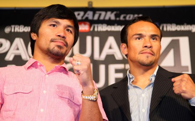 Manny Pacquiao, left, and Juan Manuel Marquez face the media cameras during a Press Conference at Beverly Hills Hotel in California on Monday. Photo: AFP