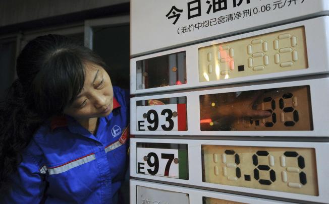 A worker updates prices at a petrol station in Hefei.