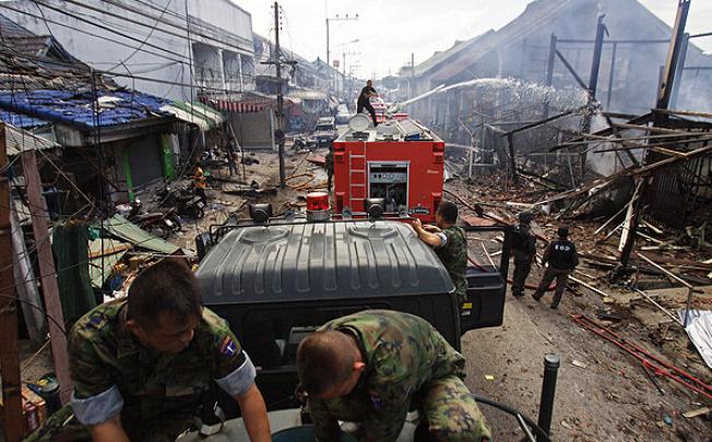 Fire crews douse the site of car bomb attack in Sai Buri town, in Thailand's restive southern province of Pattani on Friday. Photo: AFP