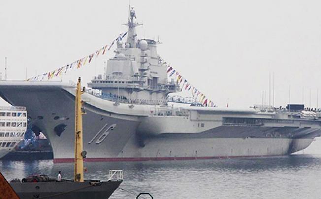 The 300-metre ship, a former Soviet carrier called the Varyag, is handed over to the navy. Photo: SCMP Pictures