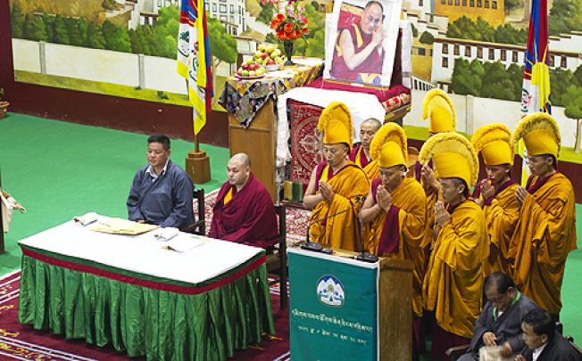 Exiled Tibetan Buddhist monks, in yellow ceremonial hats, pray during the opening ceremony of a special meeting in Dharamshala, India, on Tuesday. Photo: AP