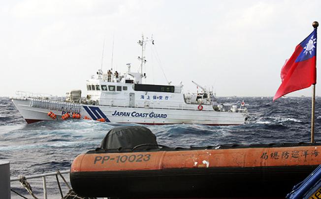 A Japanese coastguard vessel approaches a Taiwanese boat last week in waters near the dispute Diaoyu islands. Photo: EPA