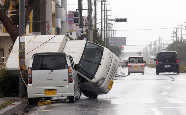 A light vehicle is overturned by Typhoon Jelawat in Itoman, Okinawa. Photo: EPA