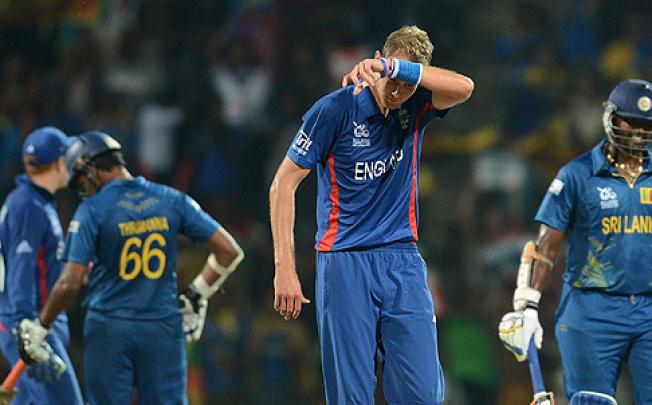 England's captain Stuart Broad (centre) wipes his face as his opponents from Sri Lanka go back to their creases. Photo: AFP