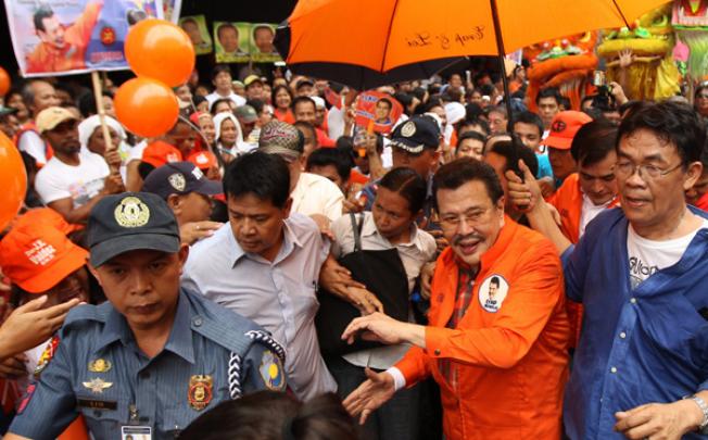 Former Philippine president Joseph Estrada (second right) is greeted by supporters outside the Commission on Elections building in Manila on Tuesday. Photo: EPA