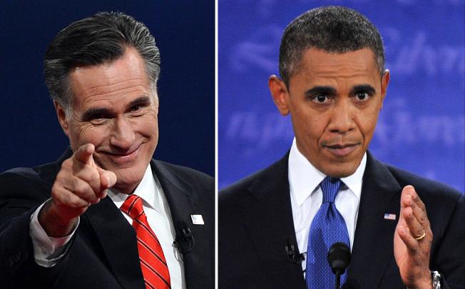 US President Barack Obama (R) speaks during his debate with Republican Presidential candidate Mitt Romney (L), who greets the audience at the conclusion in Denver, Colorado, on October 3, 2012. Photo: AFP