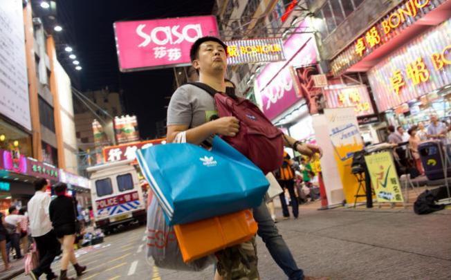A shopper holds multiple shopping bags in Causeway Bay during the October 1 "Golden Week" in Hong Kong. Photo: SCMP
