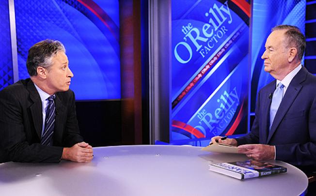 Jon Stewart (left) appears on Bill O'Reilly's show on Fox News in 2010. They held a mock debate on Saturday, bantering about birth control and former US president George W Bush. Photo: AP