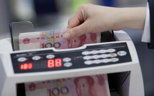 The yuan spiked against the US dollar in intraday trading, pushed up by quantitative easing in the US and expectations of policy measures from Beijing. Photo: Bloomberg