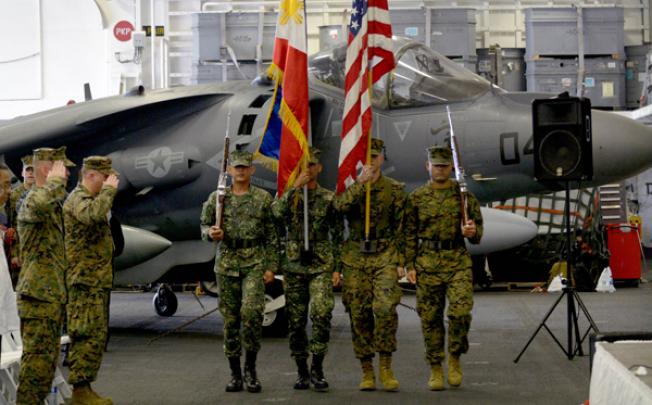 US and Philippine Marines carry their respective colours at the formal opening of the annual Philippine-US Amphibious Landing Exercises aboard the USS Bonhomme Richard on Monday. Photo: AFP