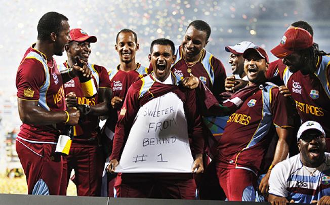 West Indies' cricketer Denesh Ramdin (centre) celebrates with teammates in Colombo, Sri Lanka, on Sunday. Photo: AP