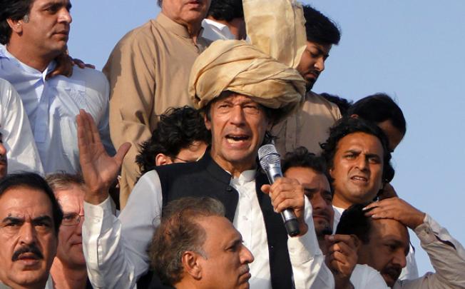 Pakistan's ex-cricket star-turned-politician Imran Khan (centre) addresses his supporters during a peace march in Tank, Pakistan, on Sunday. Photo: AP